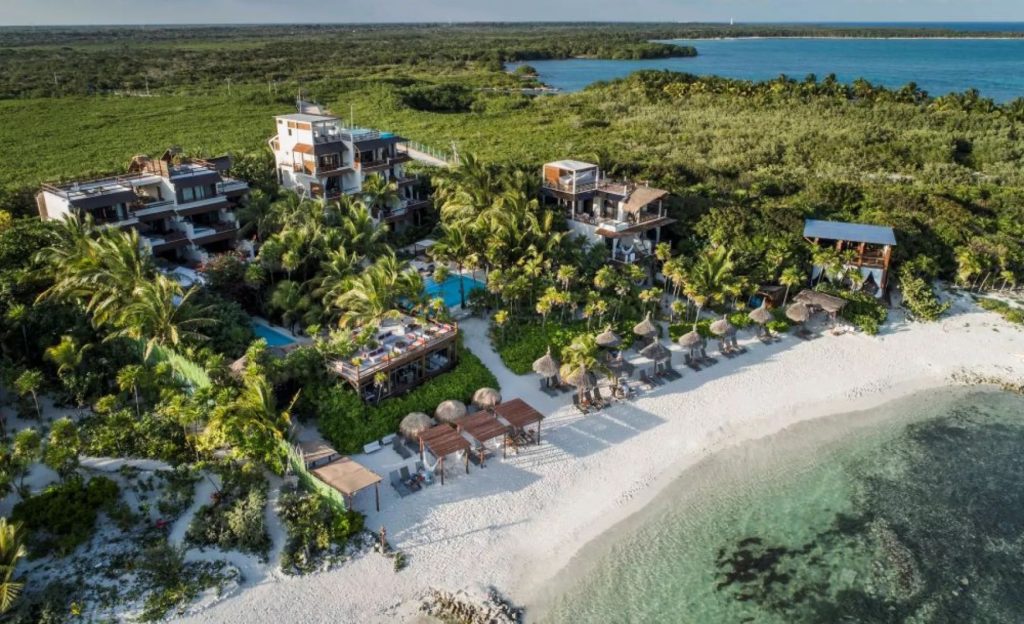 Bay with mountains, vegetation, and a few luxury hotels.