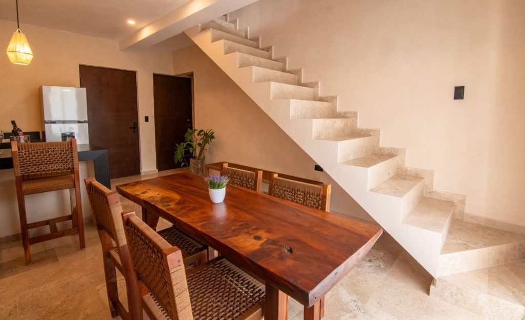 Open-concept apartment with a modern wooden kitchenette and ample space.