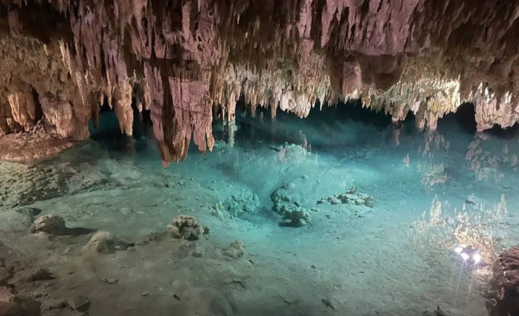 Cave system with clear waters and stalactites