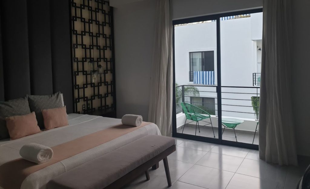 Modern room featuring a cozy white bed and sleek gray accents.