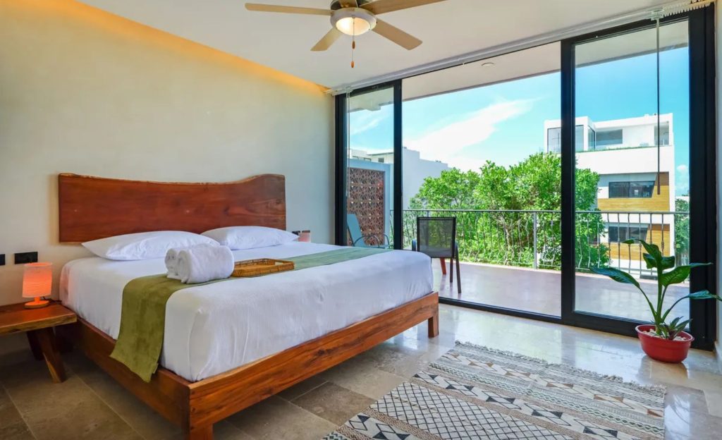 Comfortable hotel room with a white bed and wooden tones.