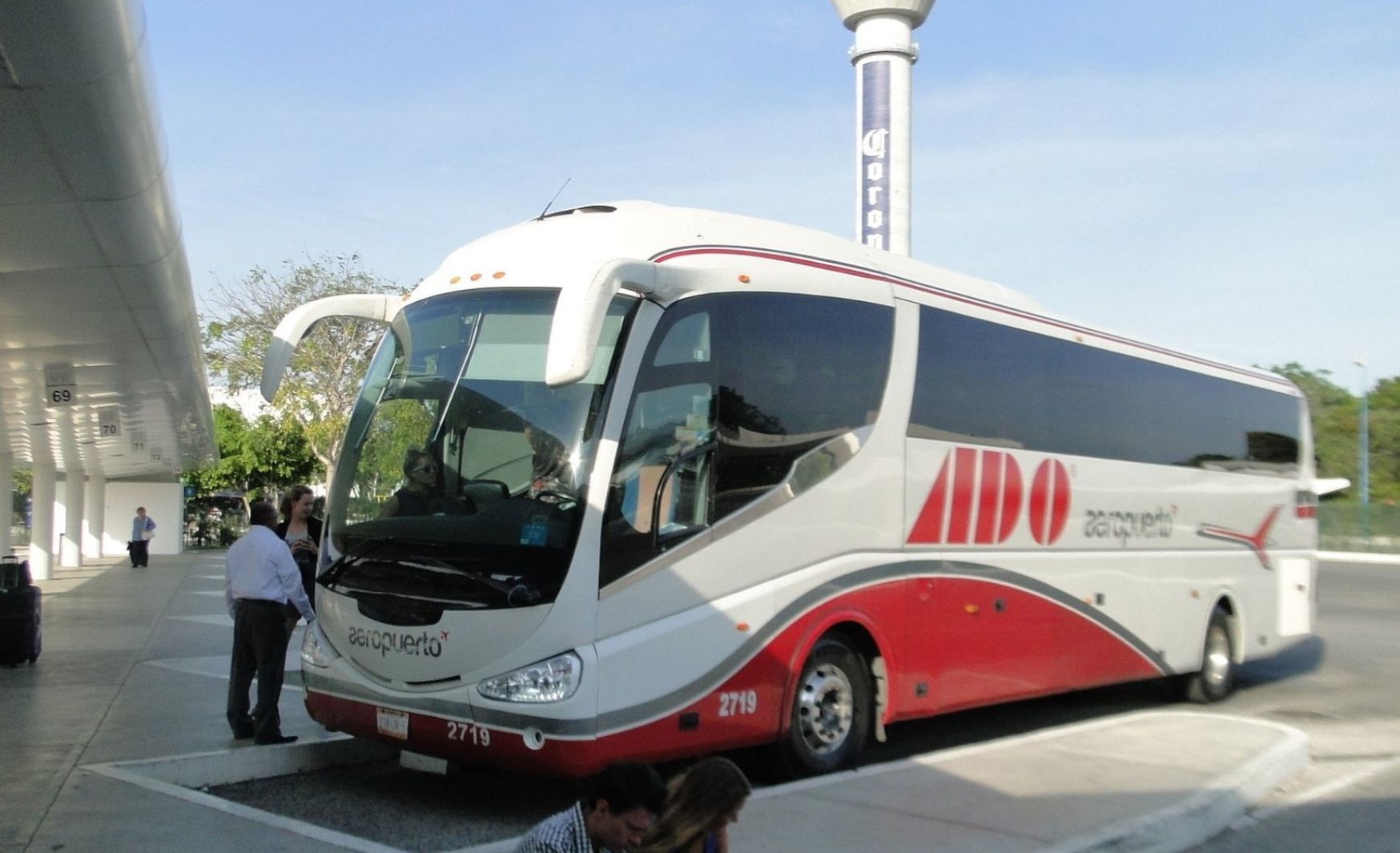ADO bus leaving Tulum International Airport, providing transportation to Tulum City.