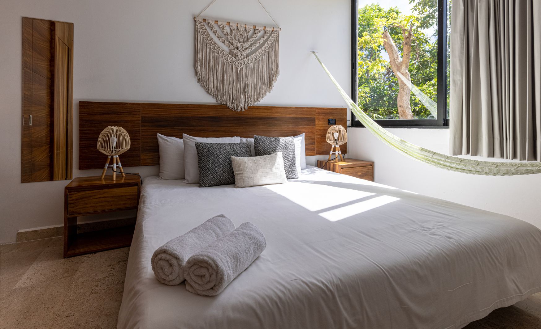 Stylish Tulum-inspired hotel room at Hotel Calea, with earthy tones, wooden accents, and a tranquil atmosphere.