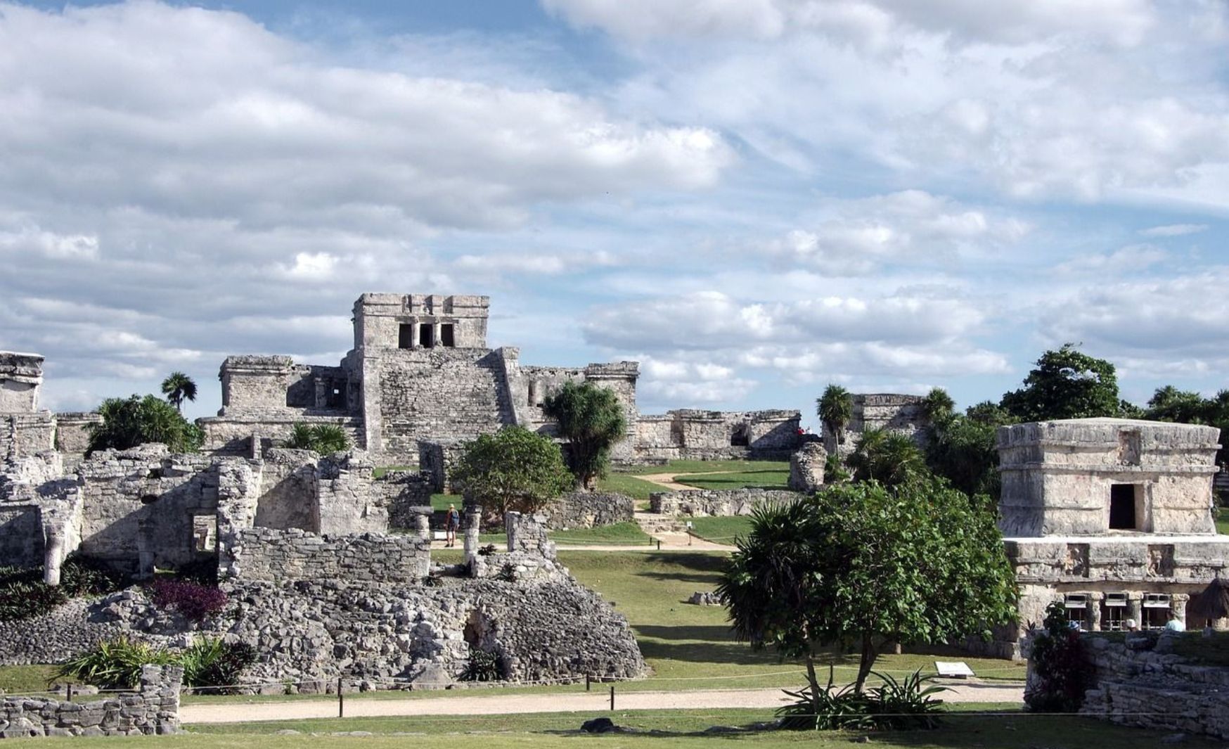 Ancient Mayan ruins in Tulum, Mexico, showcasing stone structures and historical architecture.